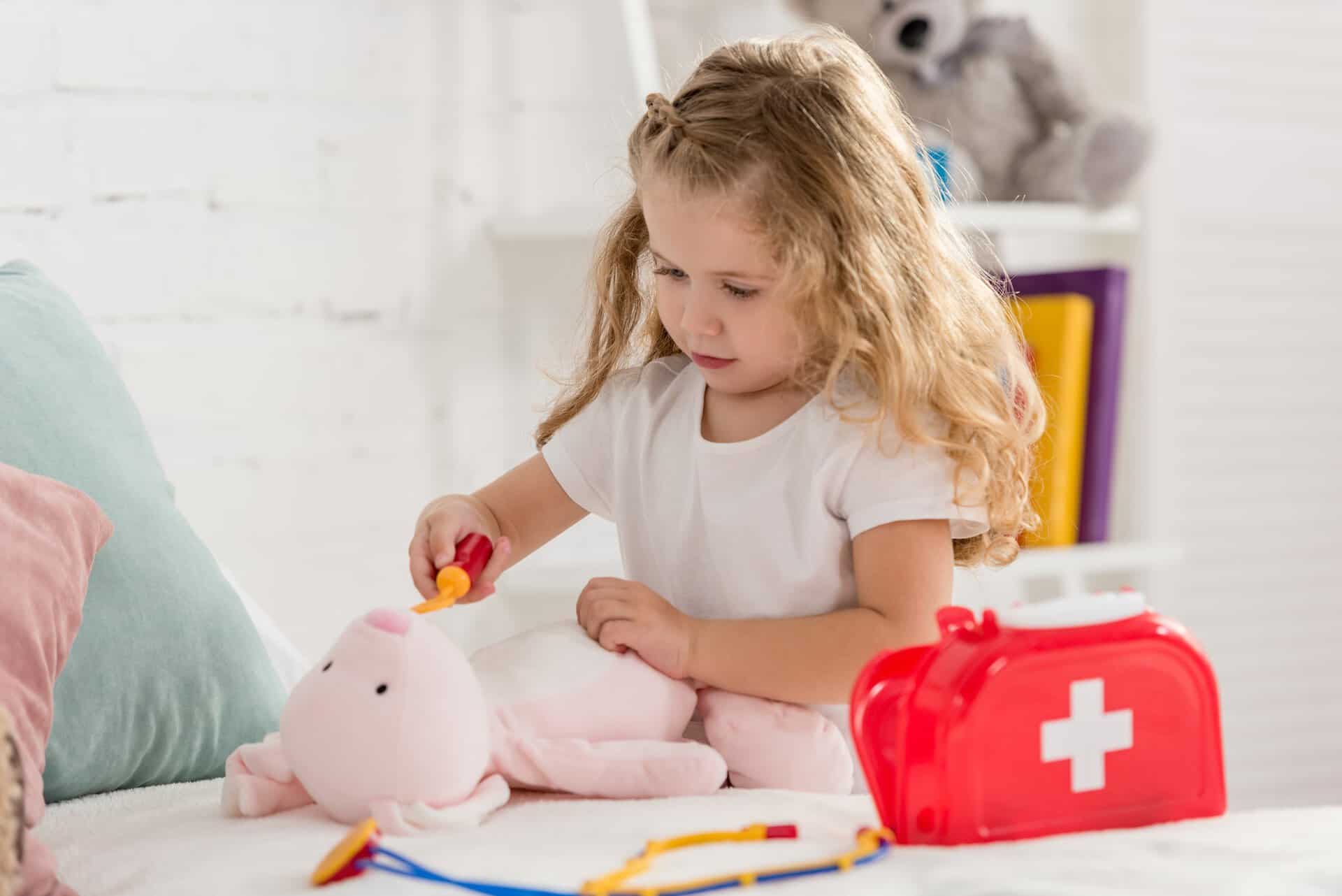 adorable kid examining rabbit toy in children room